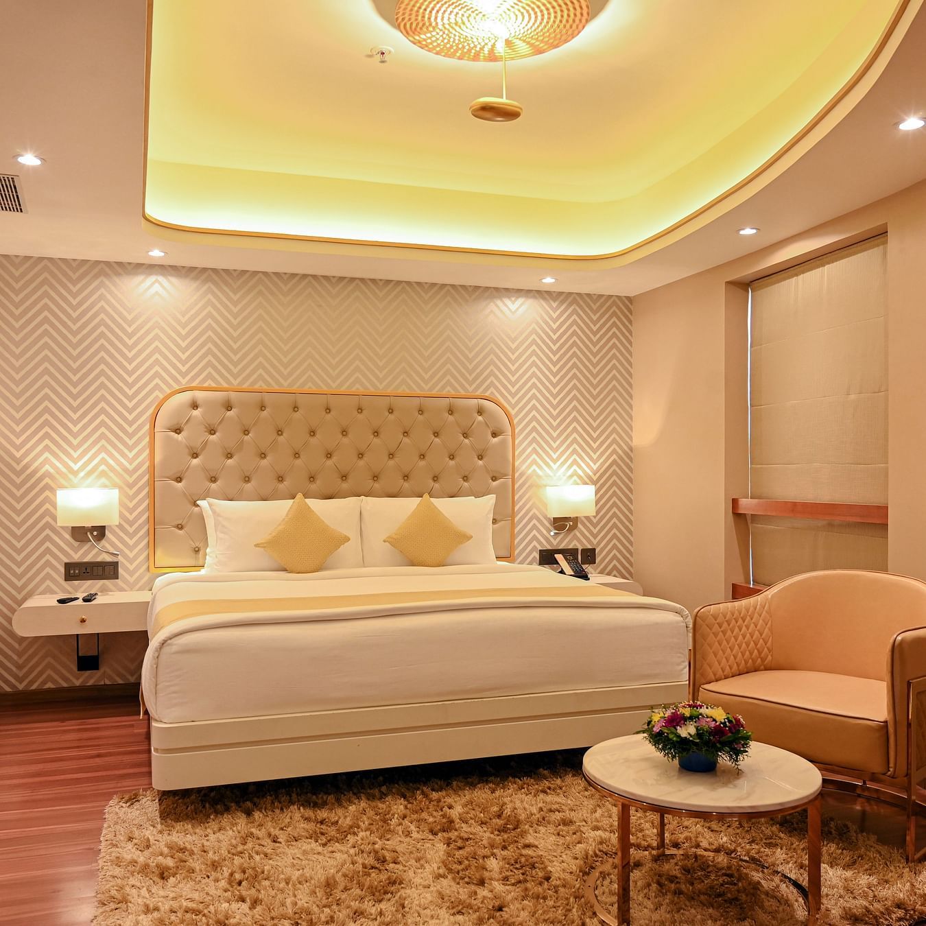 the king size bed with a sofa offered at a suite in Calicut