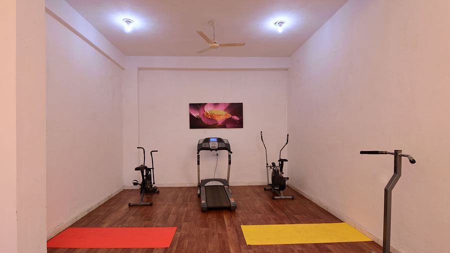 Gym area at a hotel with gym equipment's such as treadmill, dumbbells and cycle machine