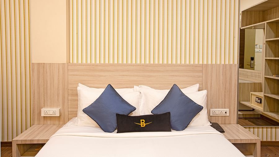A front view of the Executive room at Hotel Bawa Regency, Dadar, focusing on the plush bed.
