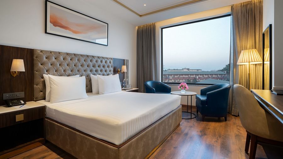 Modern hotel room with a minimalist design and natural light - Clarks Inn, Dehradun
