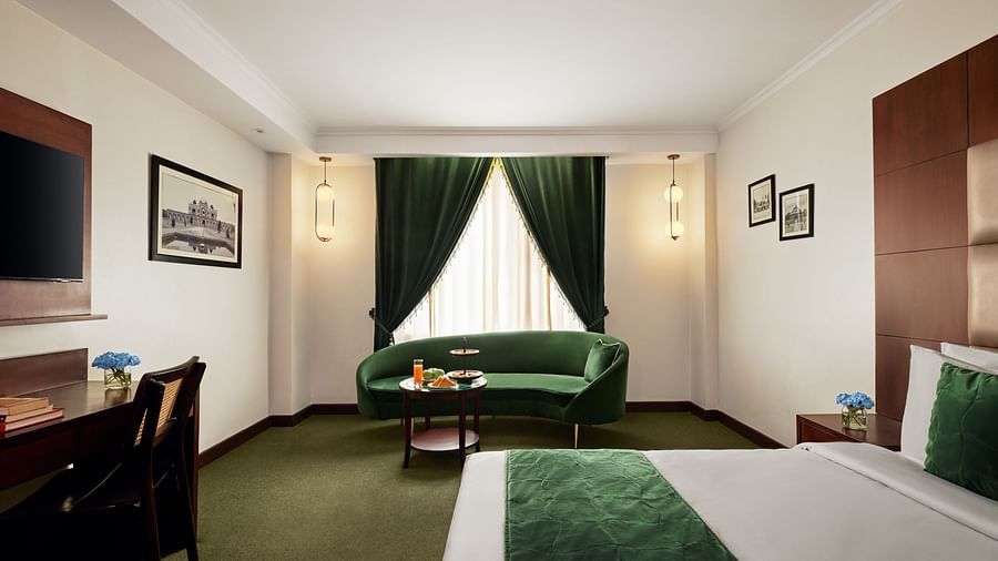 Another angle of the club room with a large sofa placed beside the bed - Deventure Sarovar Portico, Patel Nagar