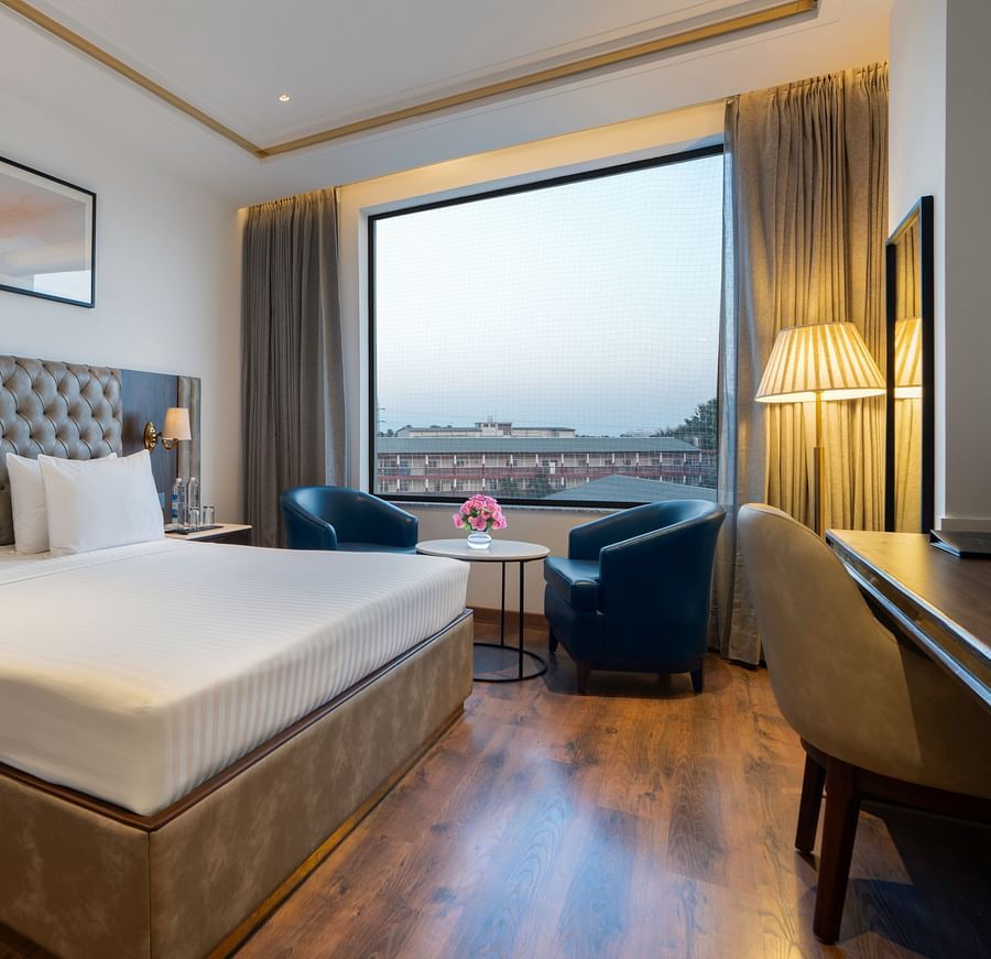 Modern hotel room with a minimalist design and natural light - Clarks Inn, Dehradun
