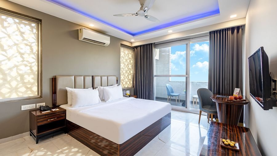 Luxury hotel room with a king size bed, modern interiors, and ambient lighting at Hotel Bawa, Gurgaon.