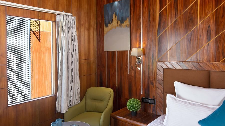 Coral Azure at Coral Reef Resort and Spa in Havelock featuring a seating space with a coffee table and a couch placed near the window next to the bed 