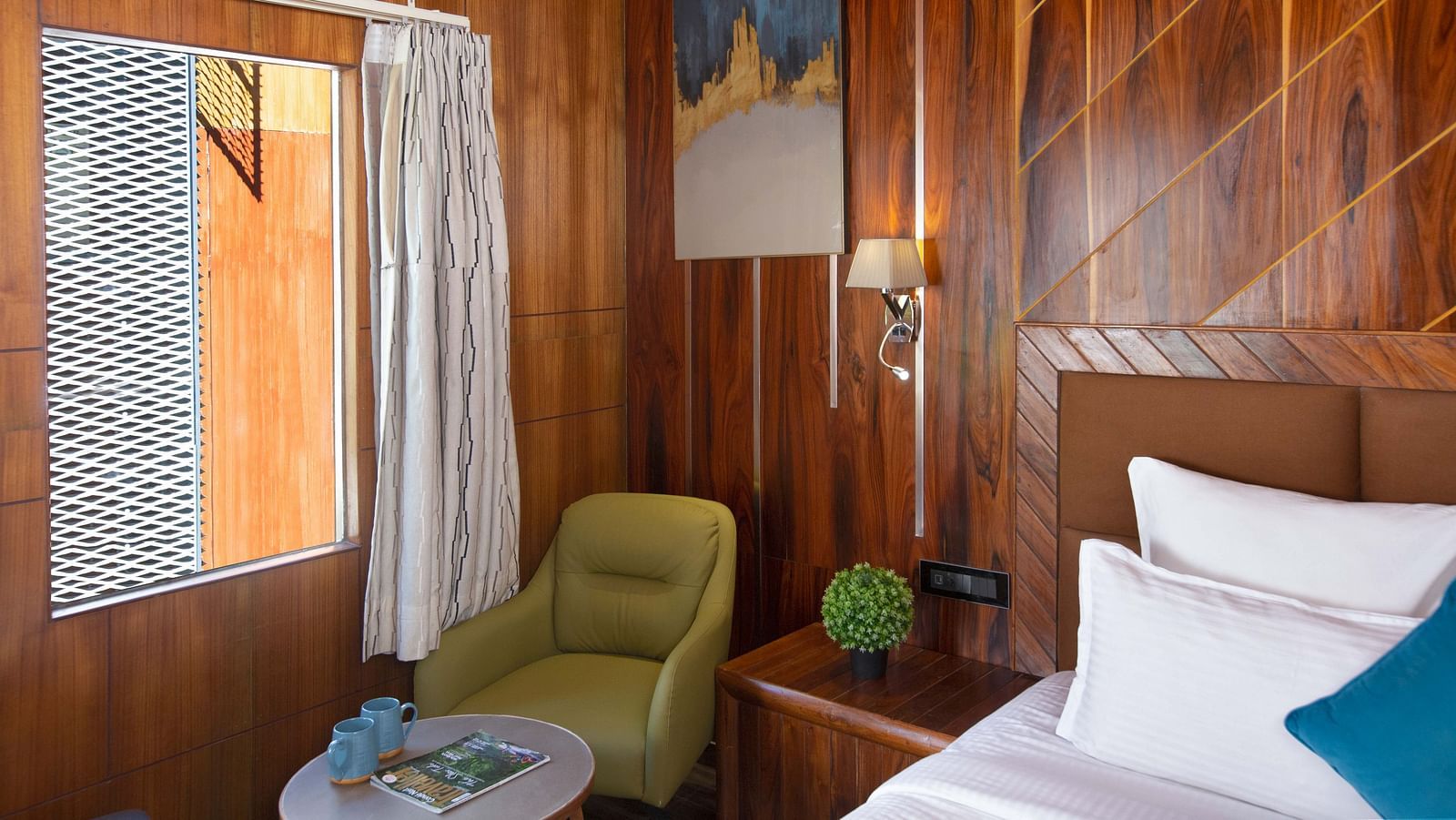 Coral Azure at Coral Reef Resort and Spa in Havelock featuring a seating space with a coffee table and a couch placed near the window next to the bed 