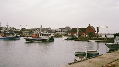 An overview of a pier with many boats in view and an open sky in the background.