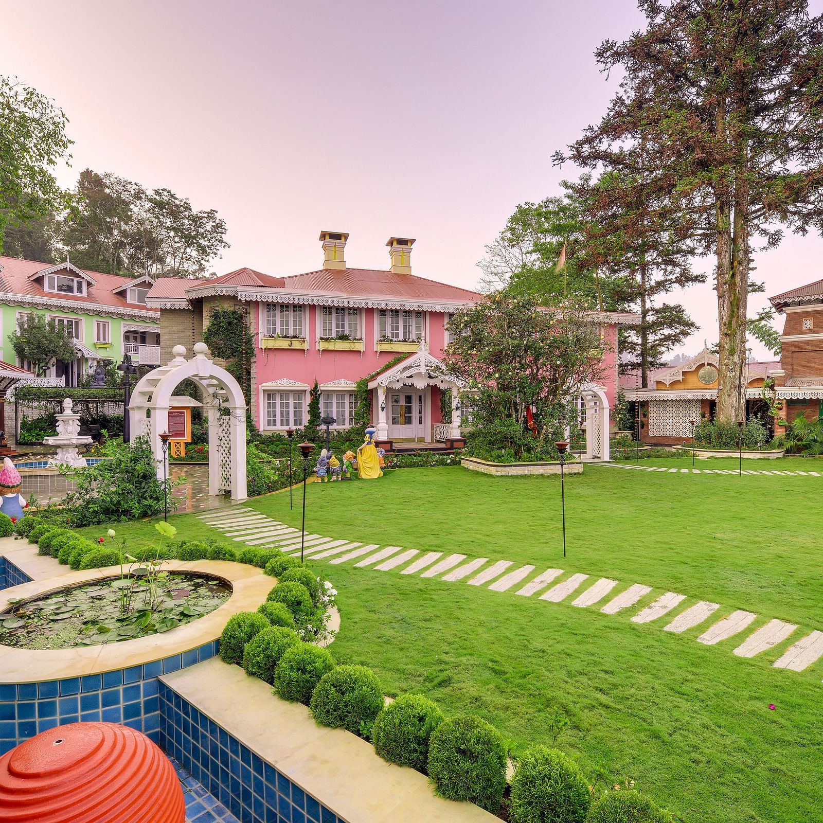 the lawn space and the resort behind the lawn - Mayfair Himalayan Spa Resort Kalimpong