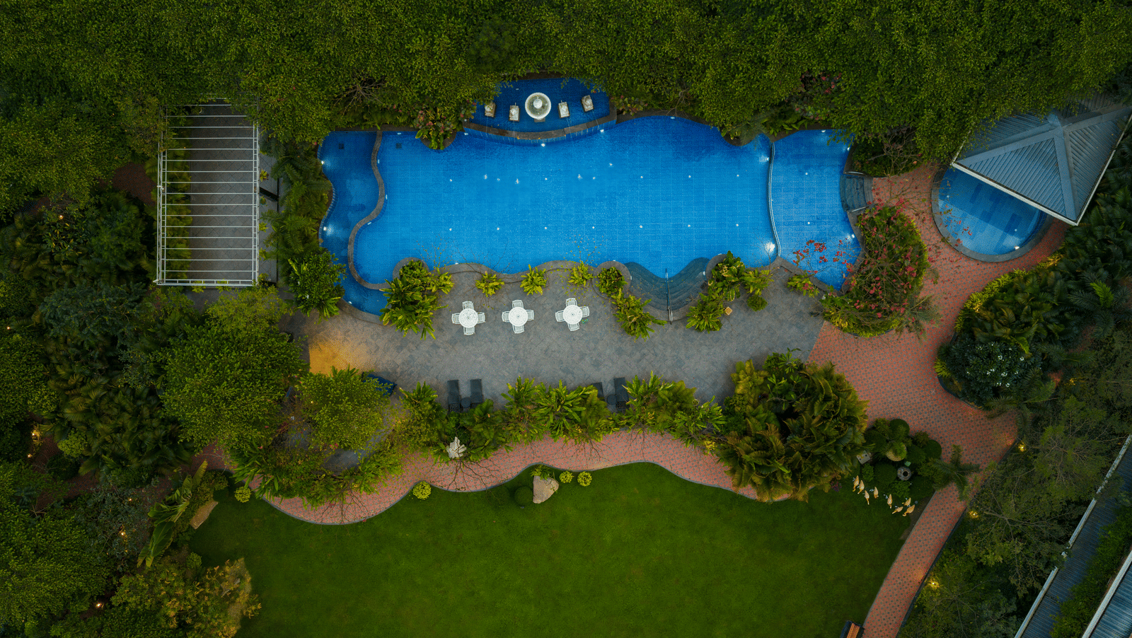 Aerial view of swimming pool and landscaped garden at Mayfair Oasis Resort, Jharsuguda