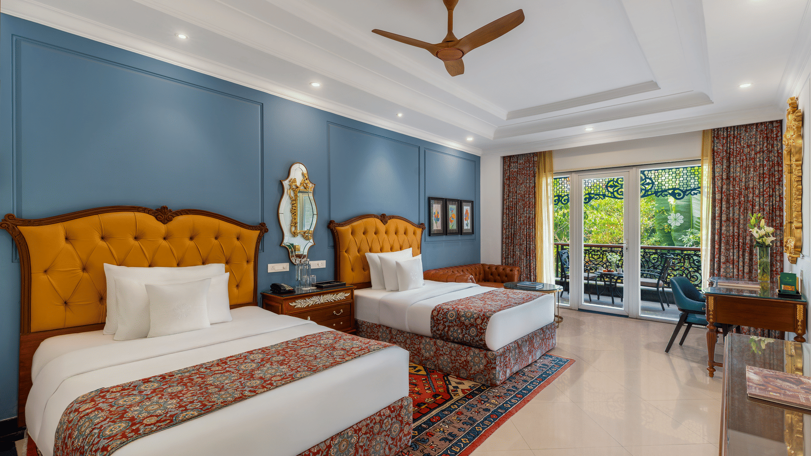 Executive room with two single beds, tufted headboards, a sofa, a writing desk and a garden-facing balcony at MAYFAIR Palm Beach Resort, Gopalpur-on-Sea.