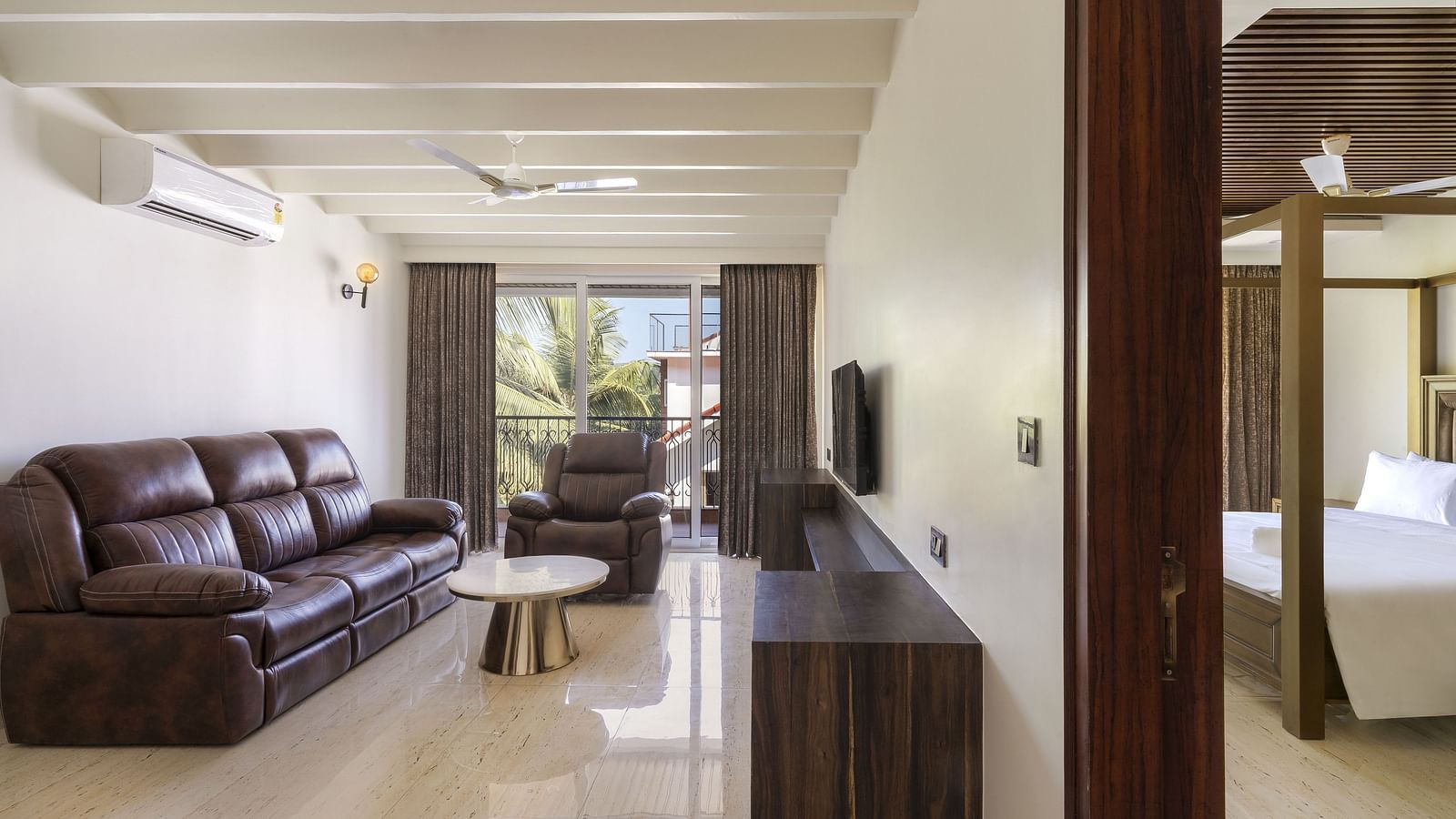 Overview of the living room with sofas and tv in view - The Tanisi Hotels & Resorts, Goa