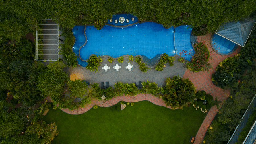 Aerial view of swimming pool and landscaped garden at Mayfair Oasis Resort, Jharsuguda