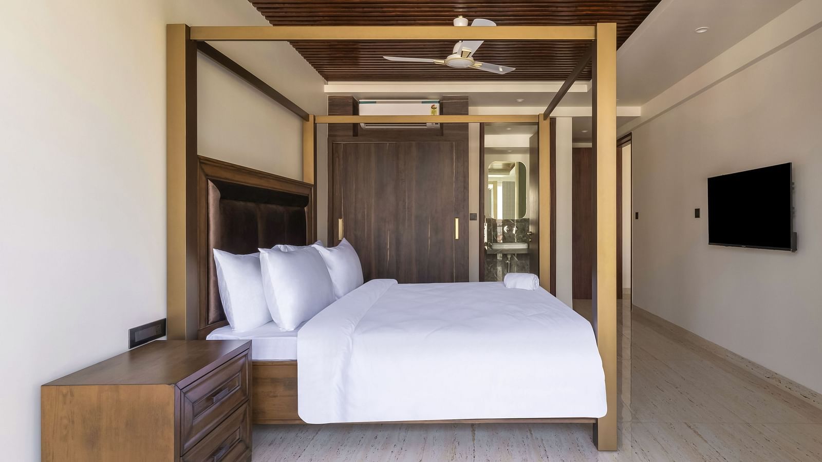 A double bed with wooden beams inside one of the rooms - The Tanisi Hotels & Resorts, Goa
