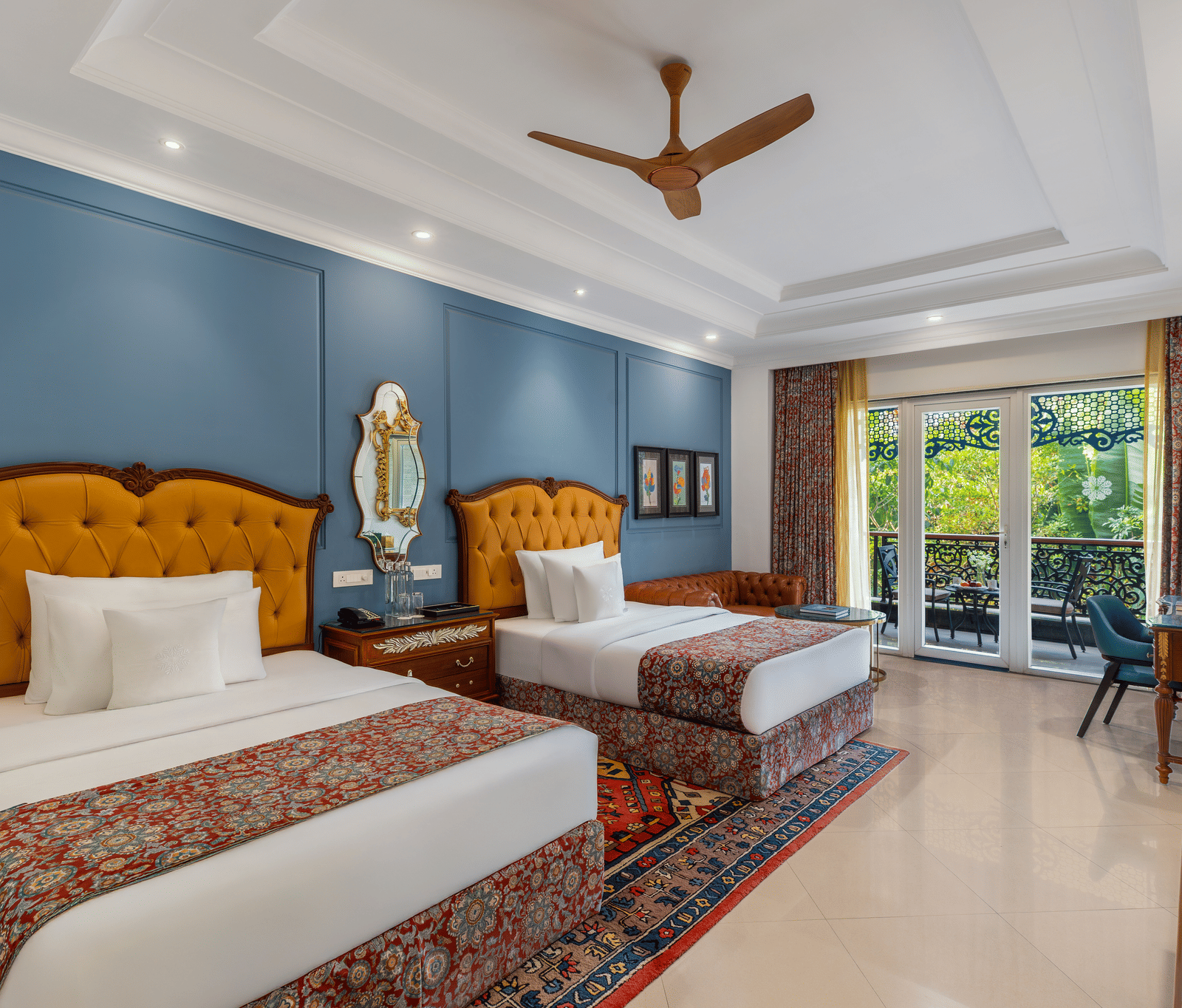 Executive room with two single beds, tufted headboards, a sofa, a writing desk and a garden-facing balcony at MAYFAIR Palm Beach Resort, Gopalpur-on-Sea.