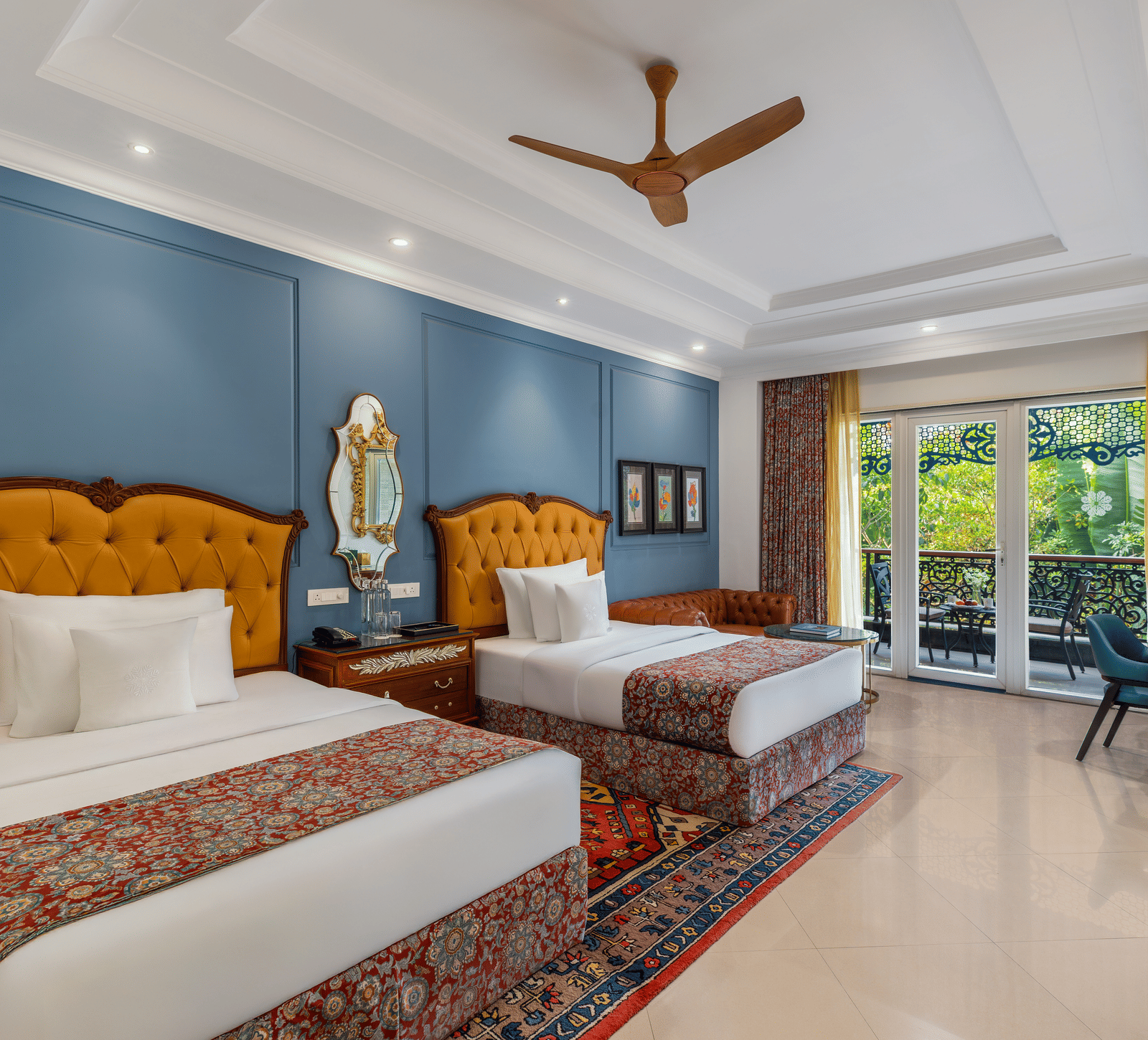 Executive room with two single beds, tufted headboards, a sofa, a writing desk and a garden-facing balcony at MAYFAIR Palm Beach Resort, Gopalpur-on-Sea.