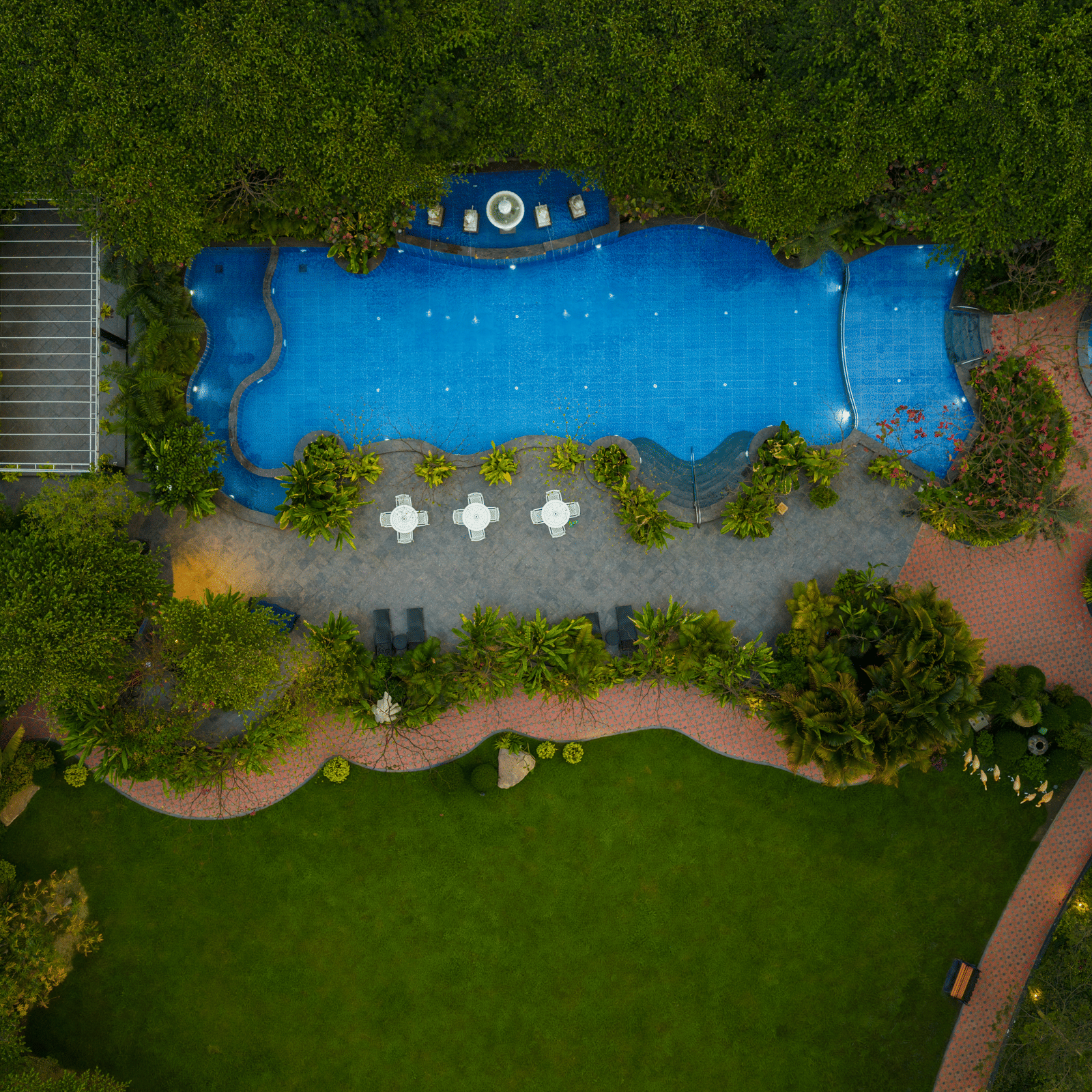Aerial view of swimming pool and landscaped garden at Mayfair Oasis Resort, Jharsuguda