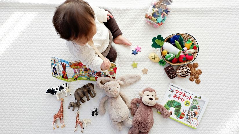 baby surrounded with baby products