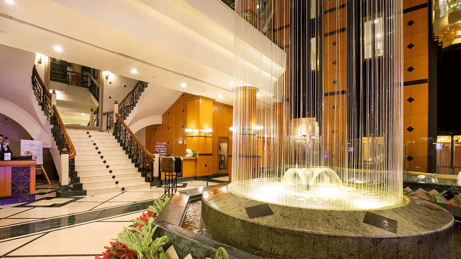 mesmerising fountain at the orchid hotel Mumbai's lobby with stairs nearby connecting other floors
