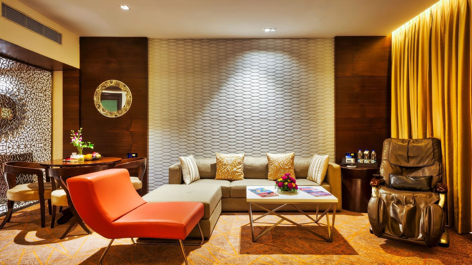An image of the living area of theme suite featuring a couch and a comfortable sofa at Grand Chennai by GRT hotels