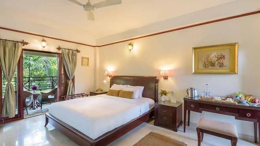 A view of Premium Double room featuring a comfy bed overlooking the green surroundings at The Riverwood Forest Retreat, Dooars