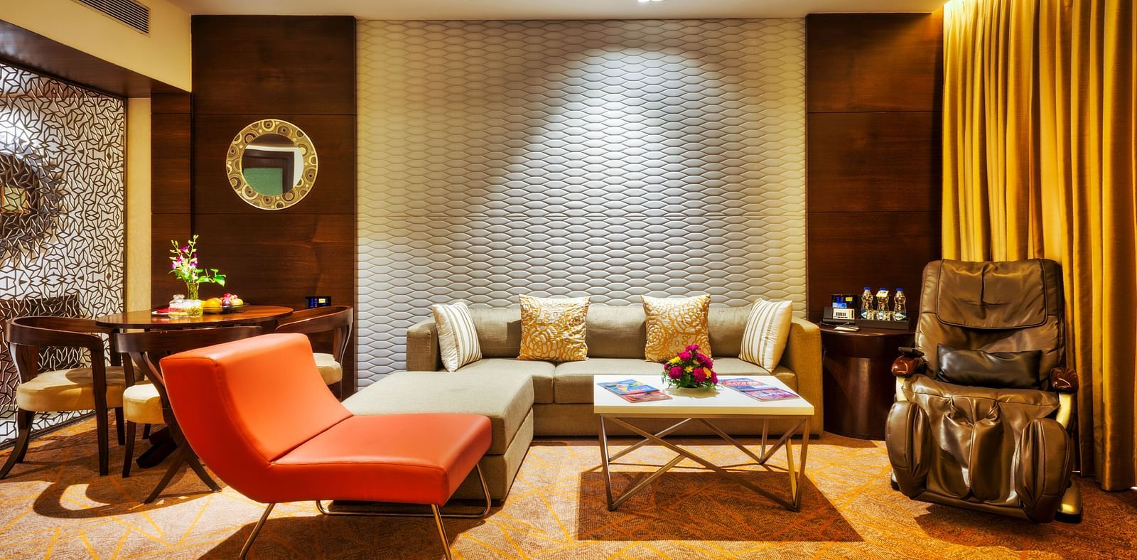 An image of the living area of theme suite featuring a couch and a comfortable sofa at Grand Chennai by GRT hotels