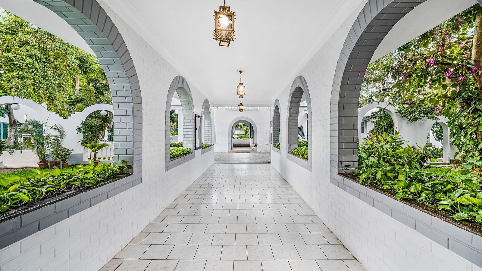 An image of a passage with beautiful architecture and lush greenery around - GReaT Trails River View Resort Thanjavur By GRT Hotels