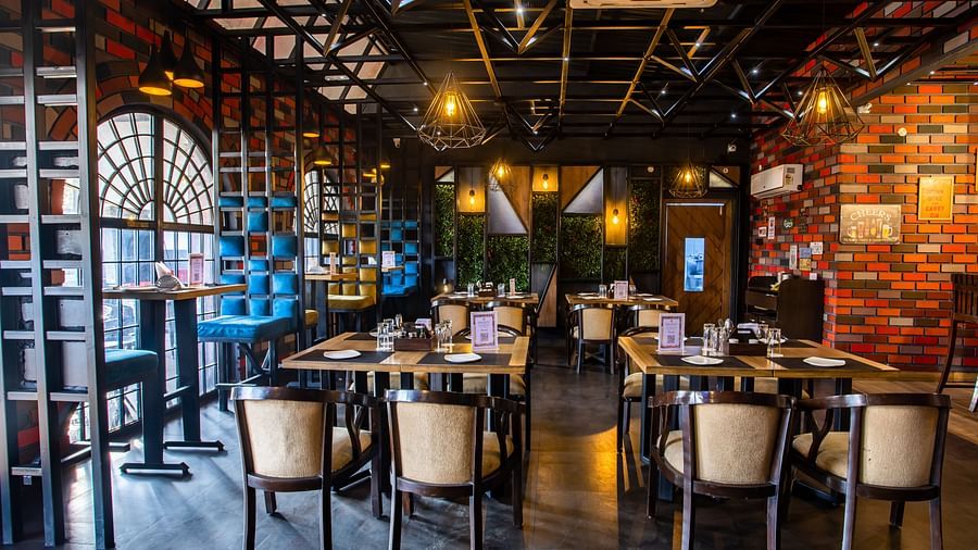 seating arrangements inside a restaurant - Wedlock Greens Hotel Resorts Dhanbad