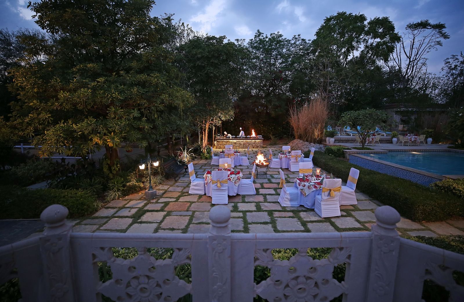 A beautifully arranged outdoor dining table under the evening sky, ready for a grand dinner - Khas Bagh, Jaipur.