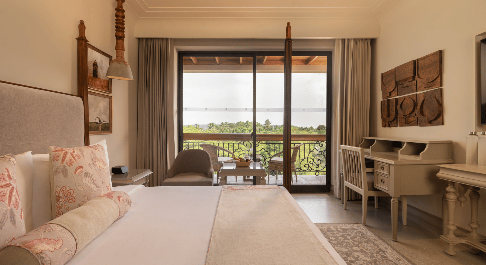 Side view of the Classic Room (Diwa) at The Evren, Vagator, featuring a beautiful balcony overlooking the lush green views.