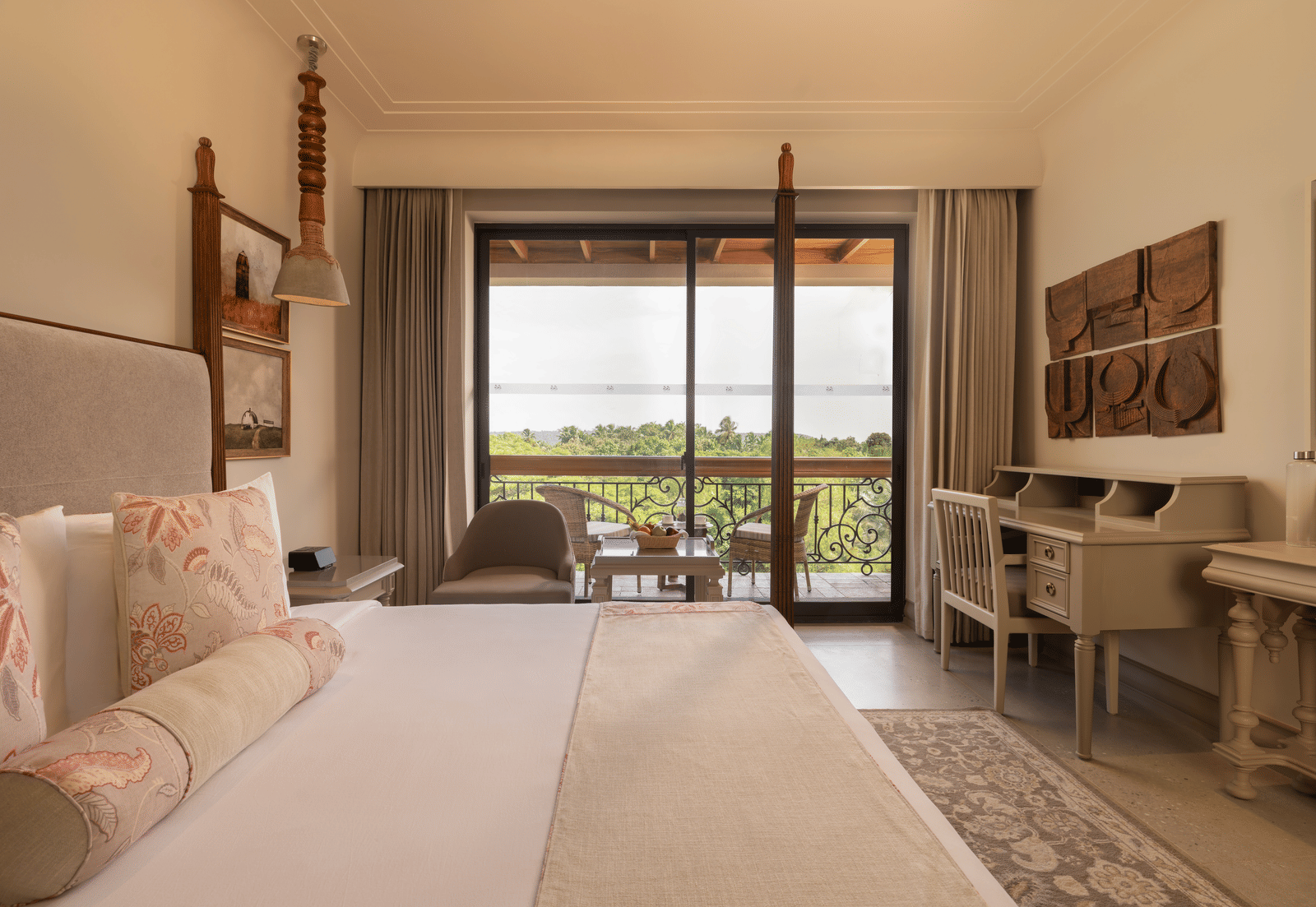 Side view of the Classic Room (Diwa) at The Evren, Vagator, featuring a beautiful balcony overlooking the lush green views.