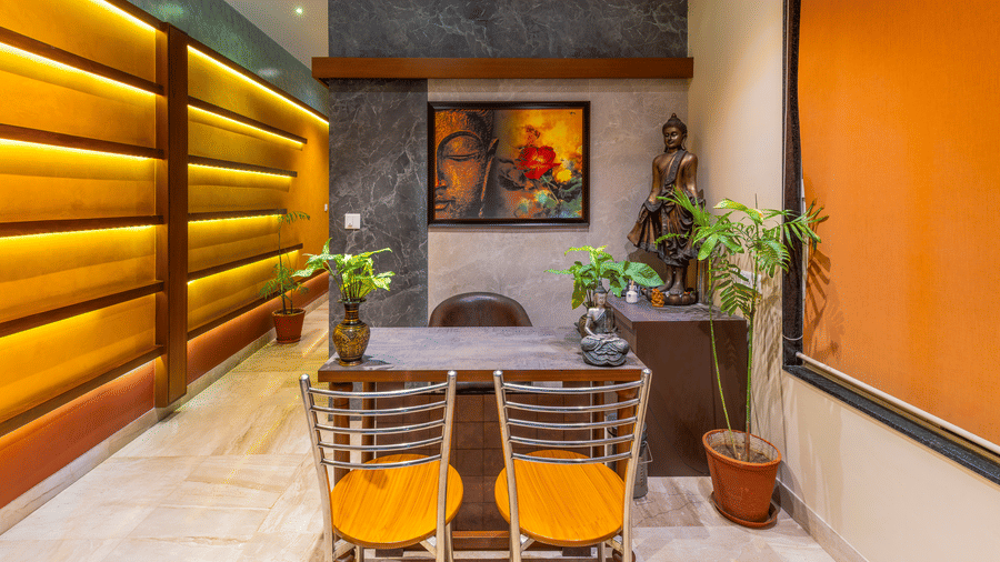 An empty enquiry desk surrounded with chairs at the Holistic Wellness Centre - Amantra Comfort Hotel