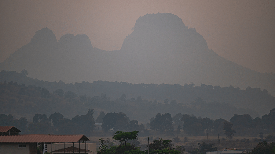 A misty landscape with prominent hills under an overcast sky at Lotus Leaf Boutique Hotel.
