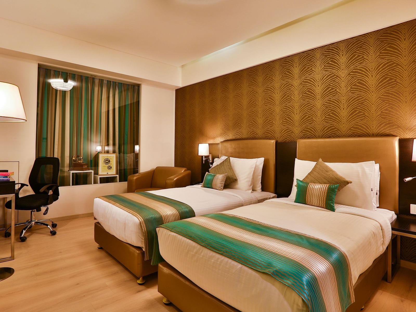 A room with twin beds, a standing desk and a work desk and chair at T24 Residency, Andheri East, Mumbai