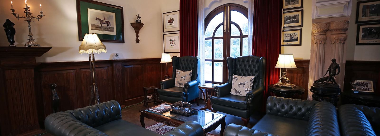 A vintage-style lounge area with elegant leather sofas and decor - Khas Bagh, Jaipur.