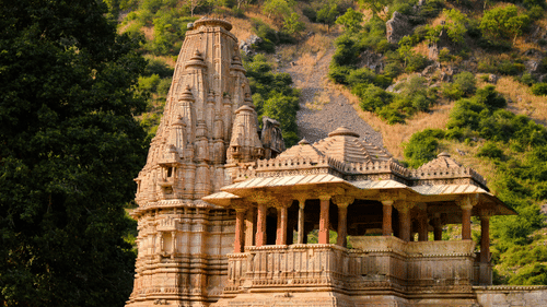 A historic temple surrounded by lush greenery and hills