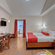 A bedroom at Holiday Home Resort, Kodaikanal, featuring a bed,  a wooden desk and a chair, and a sofa with a coffee table in the foreground. 