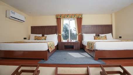 Family room with two large beds at Summit Green Lake Tea Resort & Spa, Kaziranga