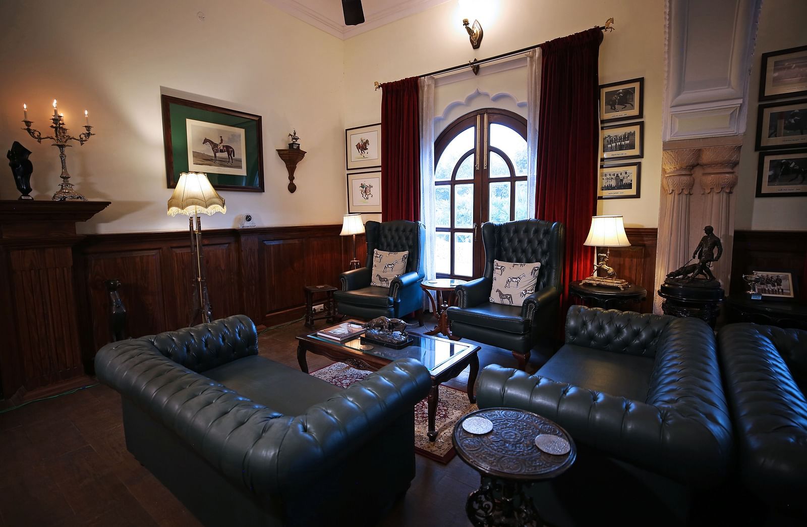 A vintage-style lounge area with elegant leather sofas and decor - Khas Bagh, Jaipur.