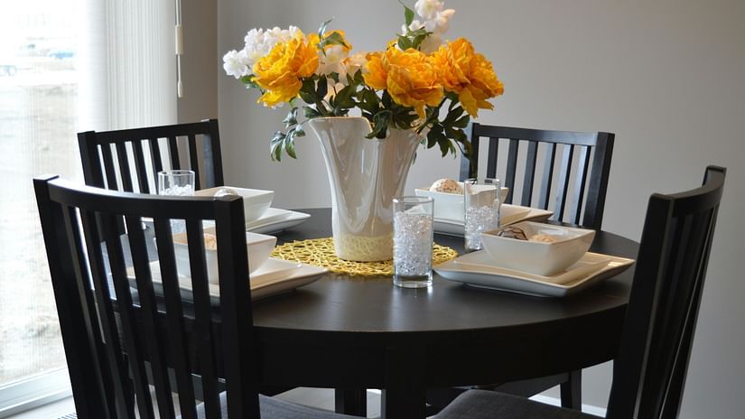 View of dining area with cutlery and flower arrangements.