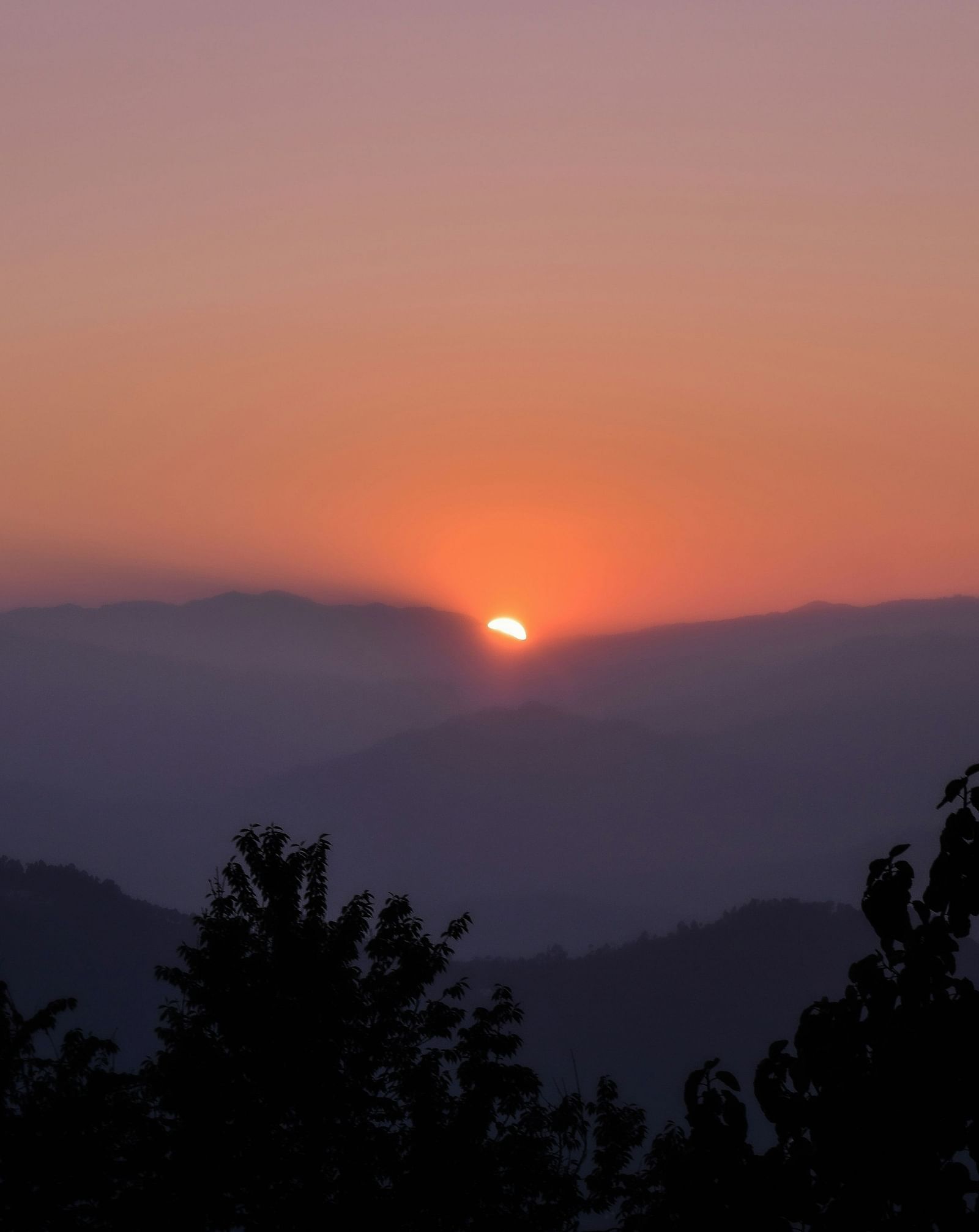 A picturesque view with sun rising from among the clouds in Darjeeling