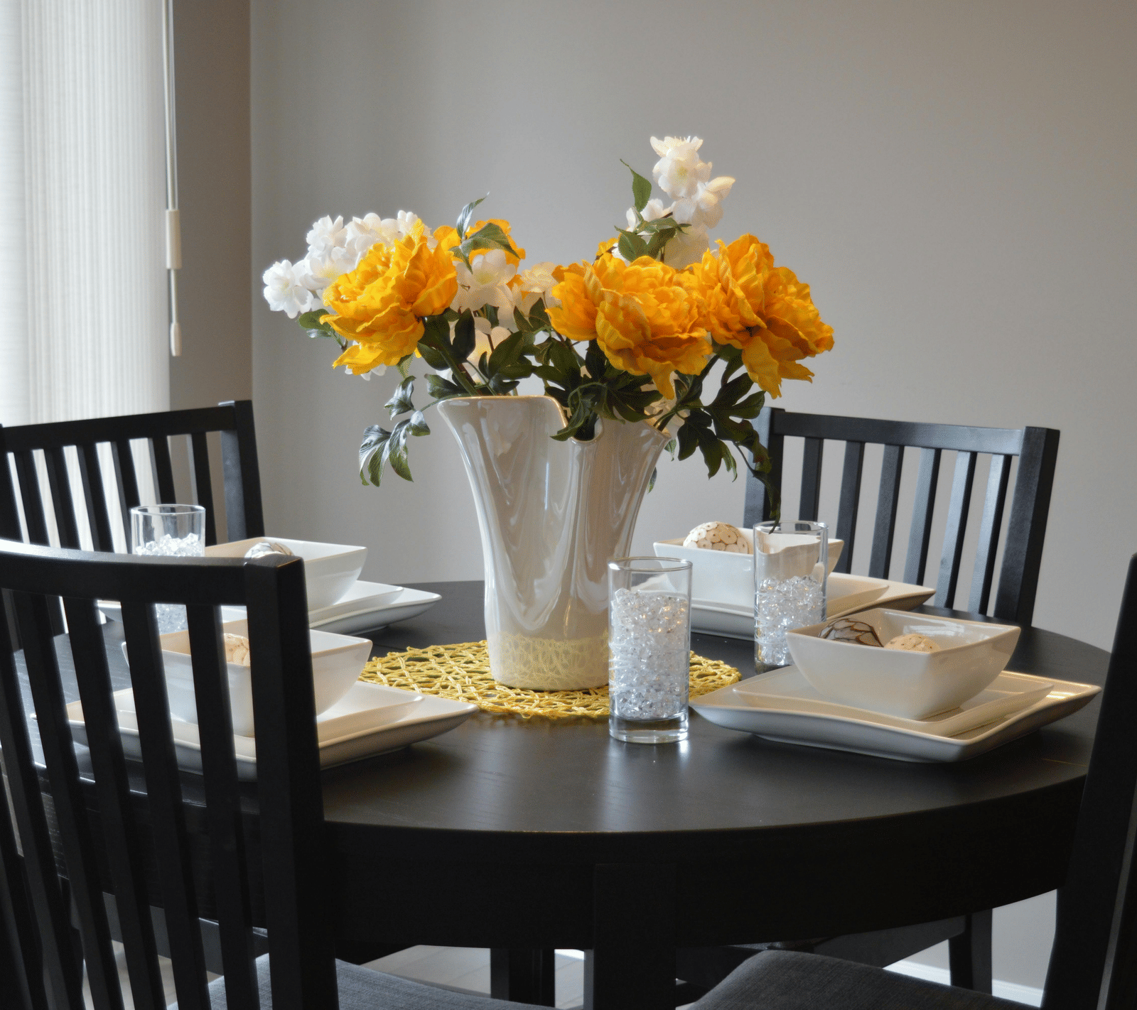 View of dining area with cutlery and flower arrangements.