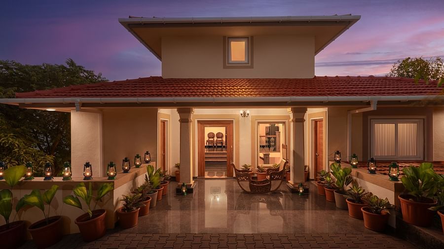 The entrance our stay in Sindhudurg featuring orange lights and potted plants - Highland Sarovar Portico, Sindhudurg