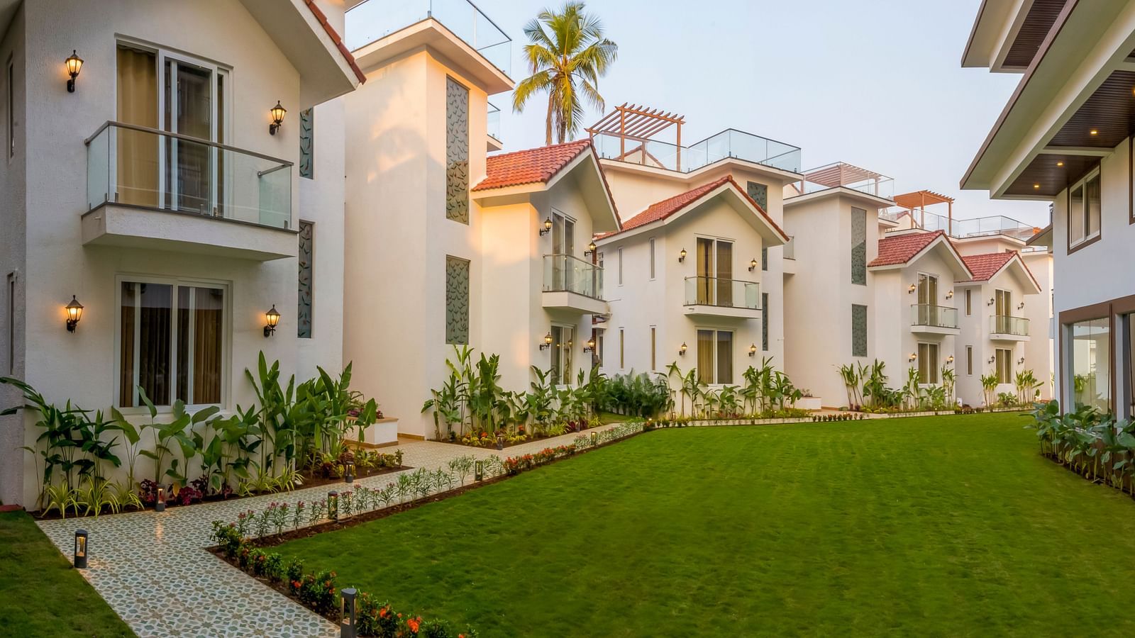 Rooms view with a manicured garden in front of it - The Tanisi Hotels & Resorts, Goa