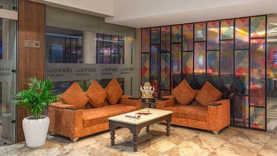 A cosy lounge area featuring comfortable seating with bright cushions, offering a relaxed space for guests to unwind - Clarks Inn Express, Near Jammu Bari Brahmana Railway Station