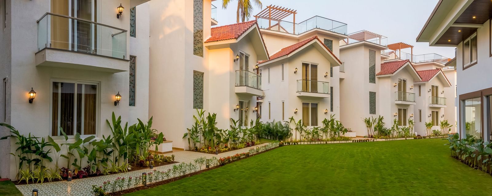 Rooms view with a manicured garden in front of it - The Tanisi Hotels & Resorts, Goa
