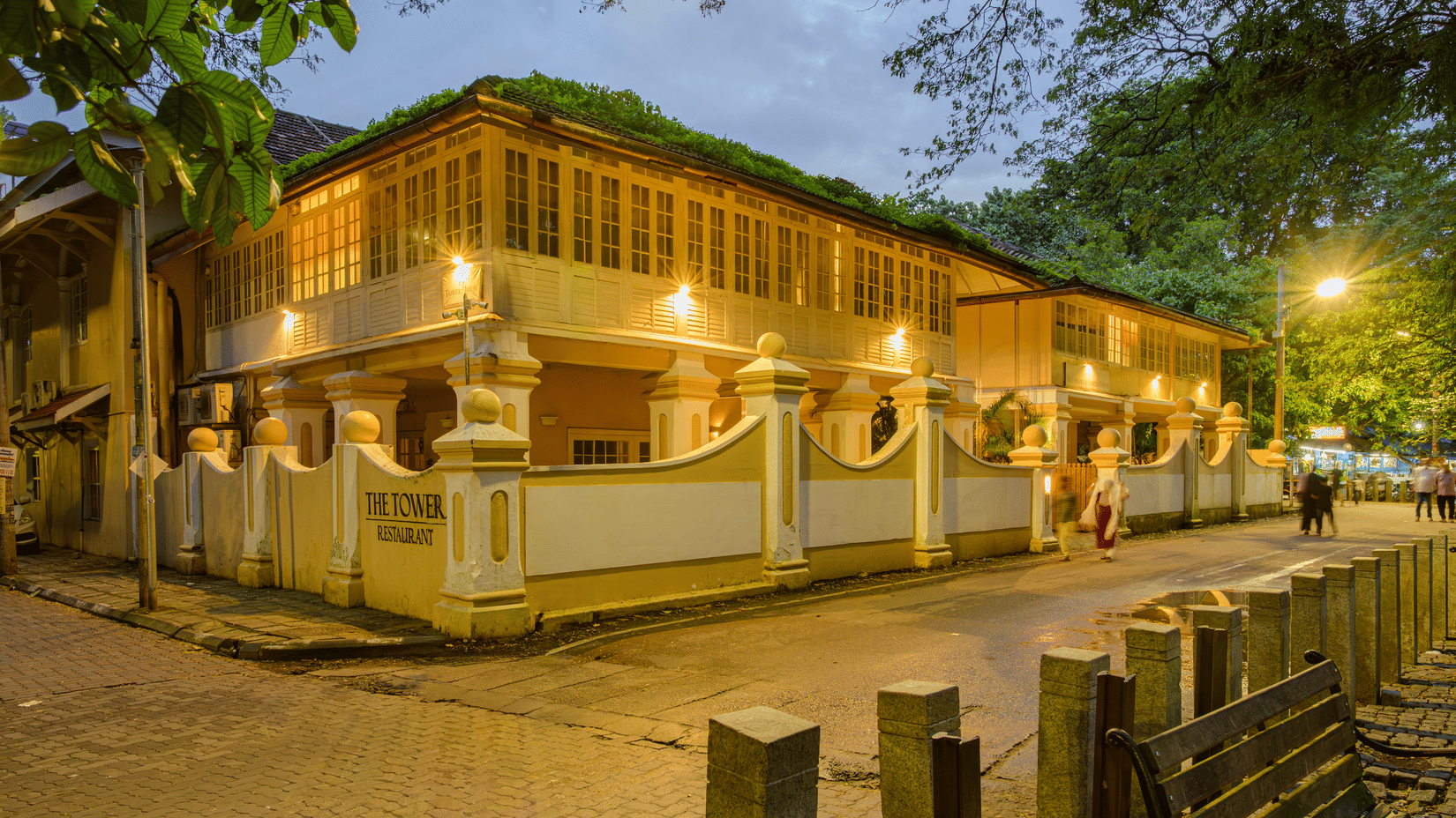 Facade of The Tower House - 17th Century, Cochin, in the dusk with lit up building and streets