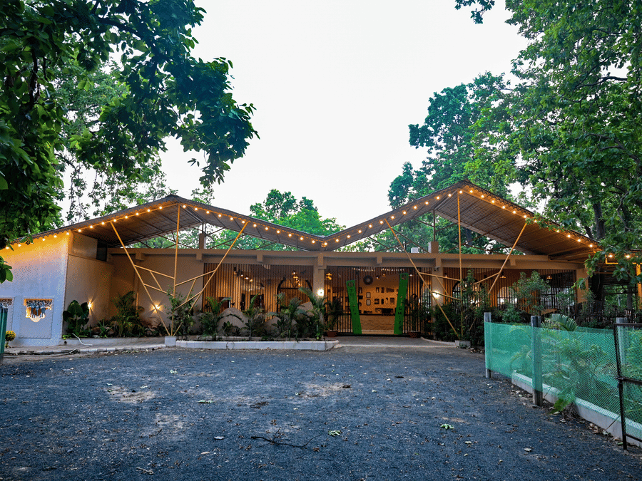 The outdoor pavilion lit at dusk at Signum Resort, Bandhavgarh