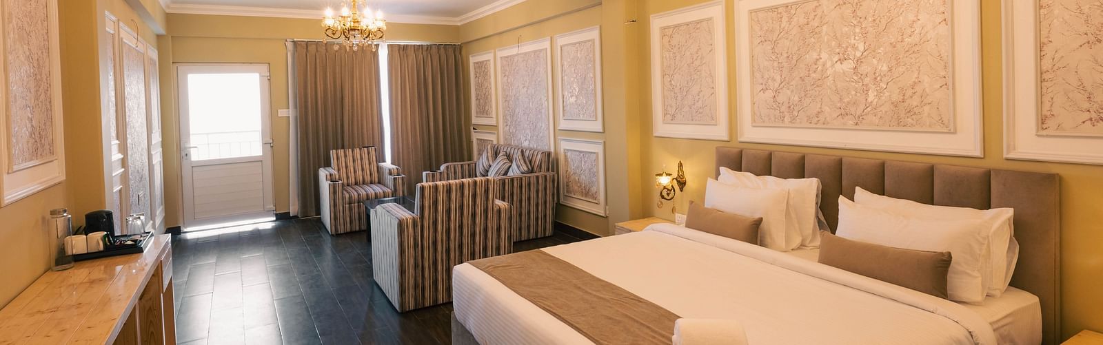 Golden Eagle Room with elegant decor, featuring a king size bed, plush seating area, chandeliers, and soft ambient lighting at Avianna Windy House Wellness Retreat & Spa