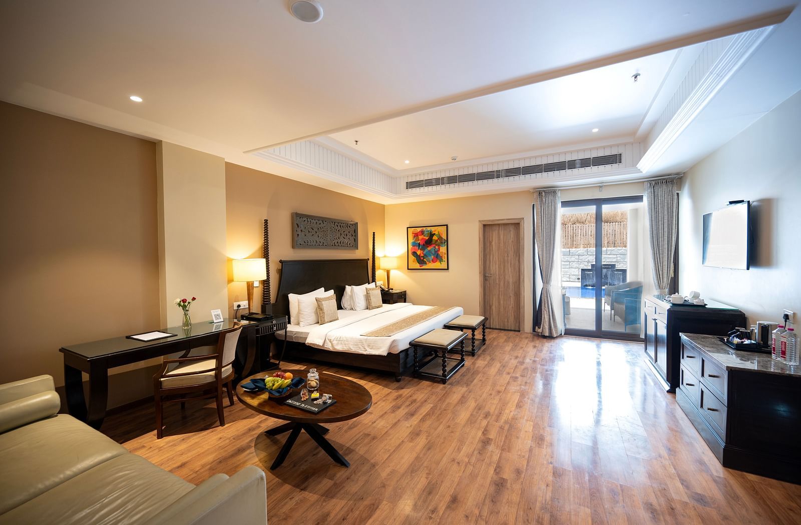 Presidential suite a king size bed placed in front of a TV at Essentia Luxury Resort & Spa, Udaipur.