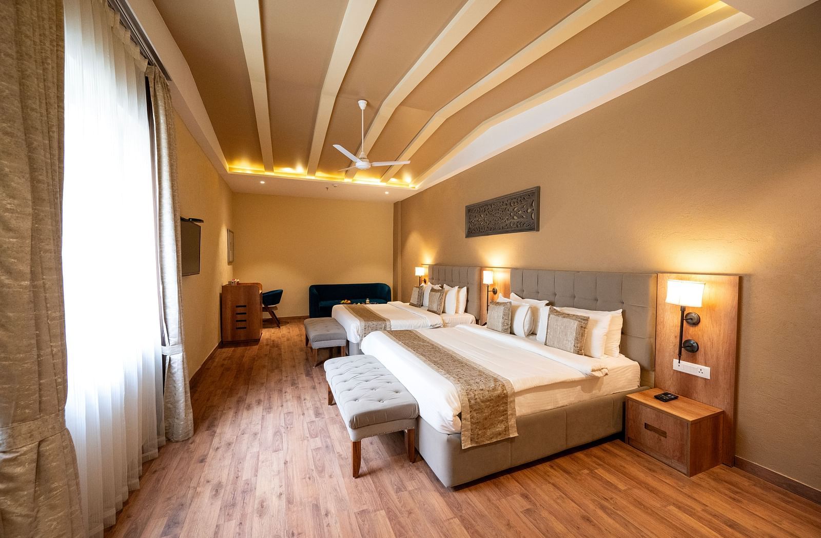 Studio quad bed room at Essentia Luxury Resort & Spa, Udaipur with modern interiors and a window with good lighting.