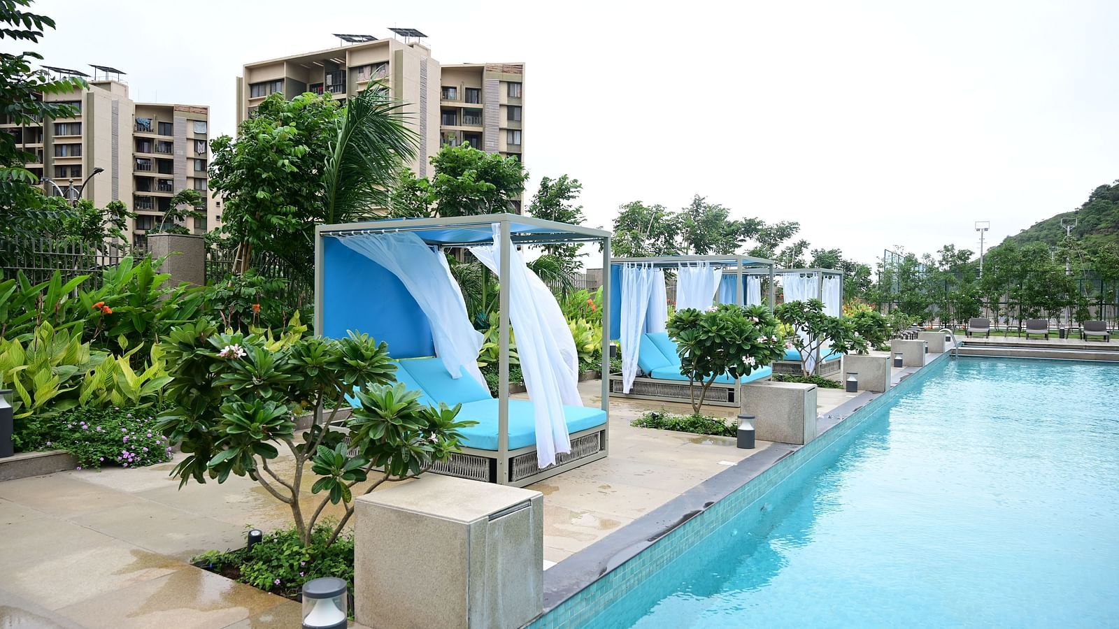 image featuring the sun loungers with curtains at club charholi, pune